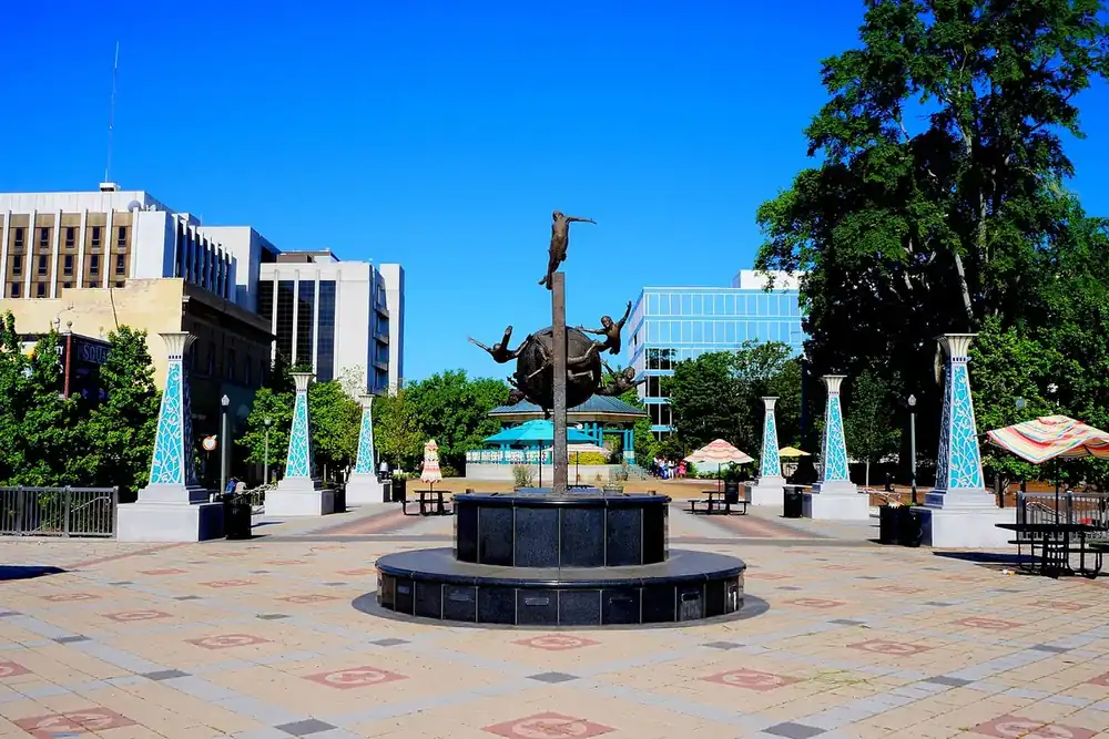 Decatur Square plaza with a fountain statue and umbrella tables in downtown Decatur, Georgia