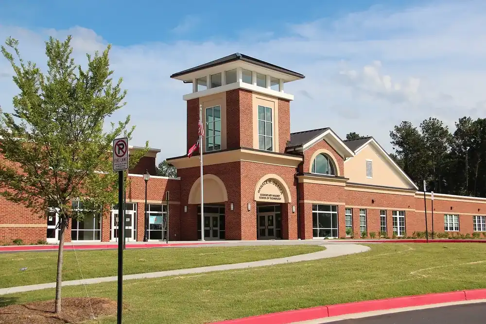 Brick elementary school with a tower entrance and sloping lawn in Panthersville, Georgia