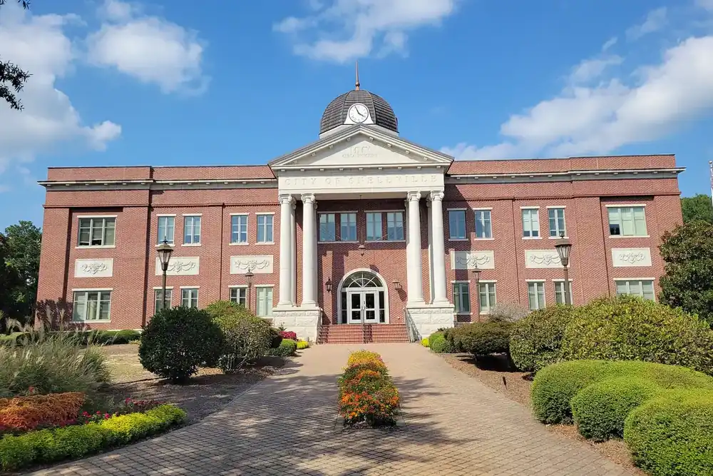 Snellville City Hall, a red brick building with a domed center and landscaped brick walkway, in Snellville, Georgia